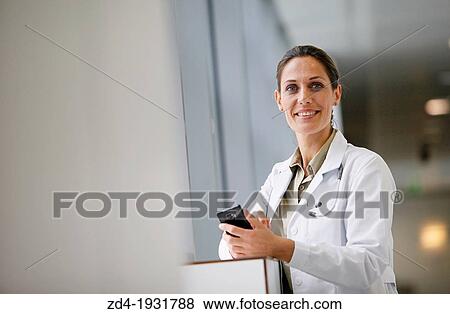 Doctor with smartphone in corridor, Onkologikoa Hospital, Oncology Institute, Case Center for prevention, diagnosis and treatment of cancer, Donostia, San Sebastian, Gipuzkoa, Basque Country, Spain View Large Photo Image Stock Photo - Doctor with smartphone in corridor, Onkologikoa Hospital, Oncology Institute, Case Center for prevention, diagnosis and treatment of cancer, Donostia, San Sebastian, Gipuzkoa, Basque Country, Spain. Fotosearch