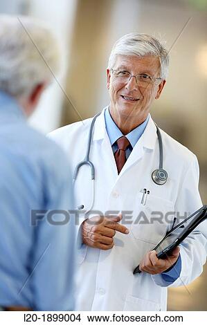 Picture - Doctor with stethoscope and tablet talking with patient, Onkologikoa Hospital, Oncology Institute, Case Center for prevention, diagnosis and treatment of cancer, Donostia, San Sebastian, Gipuzkoa, Basque Country, Spain. Fotosearch