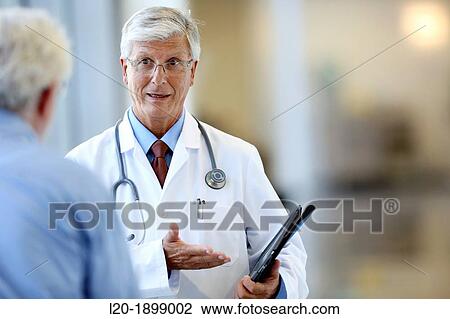 Stock Image - Doctor with stethoscope and tablet talking with patient, Onkologikoa Hospital, Oncology Institute, Case Center for prevention, diagnosis and treatment of cancer, Donostia, San Sebastian, Gipuzkoa, Basque Country, Spain. Fotosearch