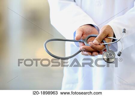 Stock Image - Doctor with stethoscope in corridor, Onkologikoa Hospital, Oncology Institute, Case Center for prevention, diagnosis and treatment of cancer, Donostia, San Sebastian, Gipuzkoa, Basque Country, Spain. Fotosearch