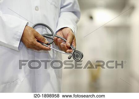 Stock Photo - Doctor with stethoscope in corridor, Onkologikoa Hospital, Oncology Institute, Case Center for prevention, diagnosis and treatment of cancer, Donostia, San Sebastian, Gipuzkoa, Basque Country, Spain. Fotosearch
