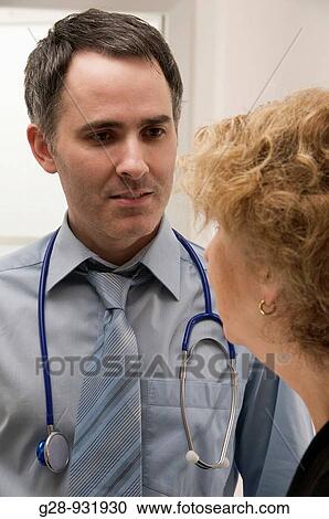doctor with stethoscope talks to senior patient View Large Photo Image Stock Image - doctor with stethoscope talks to senior patient. Fotosearch