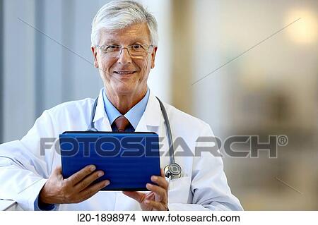 Doctor with tablet in corridor, Onkologikoa Hospital, Oncology Institute, Case Center for prevention, diagnosis and treatment of cancer, Donostia, San Sebastian, Gipuzkoa, Basque Country, Spain View Large Photo Image Picture - Doctor with tablet in corridor, Onkologikoa Hospital, Oncology Institute, Case Center for prevention, diagnosis and treatment of cancer, Donostia, San Sebastian, Gipuzkoa, Basque Country, Spain. Fotosearch