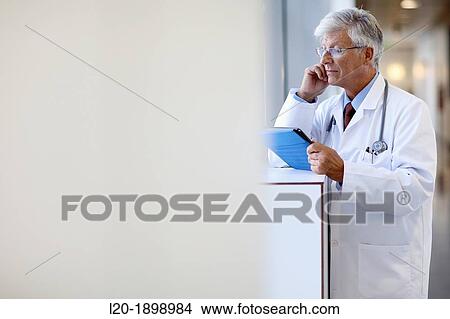 Doctor with tablet in corridor, Onkologikoa Hospital, Oncology Institute, Case Center for prevention, diagnosis and treatment of cancer, Donostia, San Sebastian, Gipuzkoa, Basque Country, Spain View Large Photo Image Picture - Doctor with tablet in corridor, Onkologikoa Hospital, Oncology Institute, Case Center for prevention, diagnosis and treatment of cancer, Donostia, San Sebastian, Gipuzkoa, Basque Country, Spain. Fotosearch