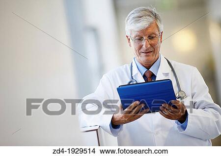Doctor with tablet in corridor, Onkologikoa Hospital, Oncology Institute, Case Center for prevention, diagnosis and treatment of cancer, Donostia, San Sebastian, Gipuzkoa, Basque Country, Spain View Large Photo Image Picture - Doctor with tablet in corridor, Onkologikoa Hospital, Oncology Institute, Case Center for prevention, diagnosis and treatment of cancer, Donostia, San Sebastian, Gipuzkoa, Basque Country, Spain. Fotosearch