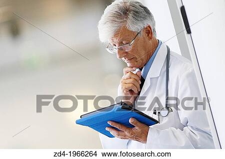 Picture - Doctor with tablet in corridor, Onkologikoa Hospital, Oncology Institute, Case Center for prevention, diagnosis and treatment of cancer, Donostia, San Sebastian, Gipuzkoa, Basque Country, Spain. Fotosearch