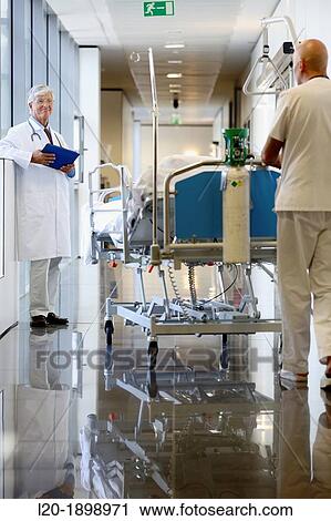 Stock Image - Doctor with tablet in corridor, Onkologikoa Hospital, Oncology Institute, Case Center for prevention, diagnosis and treatment of cancer, Donostia, San Sebastian, Gipuzkoa, Basque Country, Spain. Fotosearch