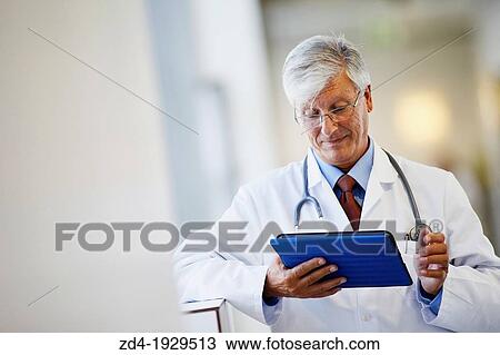 Doctor with tablet in corridor, Onkologikoa Hospital, Oncology Institute, Case Center for prevention, diagnosis and treatment of cancer, Donostia, San Sebastian, Gipuzkoa, Basque Country, Spain View Large Photo Image Stock Image - Doctor with tablet in corridor, Onkologikoa Hospital, Oncology Institute, Case Center for prevention, diagnosis and treatment of cancer, Donostia, San Sebastian, Gipuzkoa, Basque Country, Spain. Fotosearch