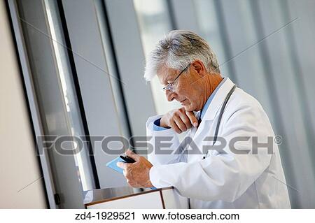 Stock Image - Doctor with tablet in corridor, Onkologikoa Hospital, Oncology Institute, Case Center for prevention, diagnosis and treatment of cancer, Donostia, San Sebastian, Gipuzkoa, Basque Country, Spain. Fotosearch