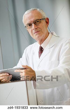 Doctor with tablet in corridor, Onkologikoa Hospital, Oncology Institute, Case Center for prevention, diagnosis and treatment of cancer, Donostia, San Sebastian, Gipuzkoa, Basque Country, Spain View Large Photo Image Stock Image - Doctor with tablet in corridor, Onkologikoa Hospital, Oncology Institute, Case Center for prevention, diagnosis and treatment of cancer, Donostia, San Sebastian, Gipuzkoa, Basque Country, Spain. Fotosearch