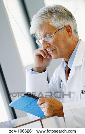 Doctor with tablet in corridor, Onkologikoa Hospital, Oncology Institute, Case Center for prevention, diagnosis and treatment of cancer, Donostia, San Sebastian, Gipuzkoa, Basque Country, Spain View Large Photo Image Stock Image - Doctor with tablet in corridor, Onkologikoa Hospital, Oncology Institute, Case Center for prevention, diagnosis and treatment of cancer, Donostia, San Sebastian, Gipuzkoa, Basque Country, Spain. Fotosearch