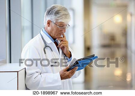 Doctor with tablet in corridor, Onkologikoa Hospital, Oncology Institute, Case Center for prevention, diagnosis and treatment of cancer, Donostia, San Sebastian, Gipuzkoa, Basque Country, Spain View Large Photo Image Stock Photo - Doctor with tablet in corridor, Onkologikoa Hospital, Oncology Institute, Case Center for prevention, diagnosis and treatment of cancer, Donostia, San Sebastian, Gipuzkoa, Basque Country, Spain. Fotosearch