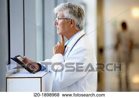 Doctor with tablet in corridor, Onkologikoa Hospital, Oncology Institute, Case Center for prevention, diagnosis and treatment of cancer, Donostia, San Sebastian, Gipuzkoa, Basque Country, Spain View Large Photo Image Stock Photo - Doctor with tablet in corridor, Onkologikoa Hospital, Oncology Institute, Case Center for prevention, diagnosis and treatment of cancer, Donostia, San Sebastian, Gipuzkoa, Basque Country, Spain. Fotosearch