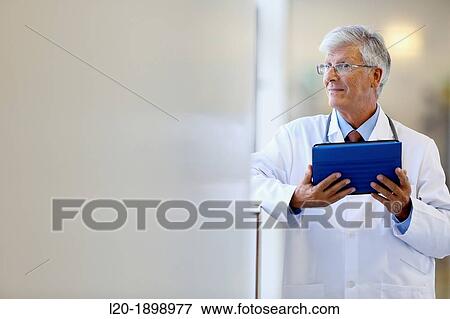 Doctor with tablet in corridor, Onkologikoa Hospital, Oncology Institute, Case Center for prevention, diagnosis and treatment of cancer, Donostia, San Sebastian, Gipuzkoa, Basque Country, Spain View Large Photo Image Stock Photo - Doctor with tablet in corridor, Onkologikoa Hospital, Oncology Institute, Case Center for prevention, diagnosis and treatment of cancer, Donostia, San Sebastian, Gipuzkoa, Basque Country, Spain. Fotosearch