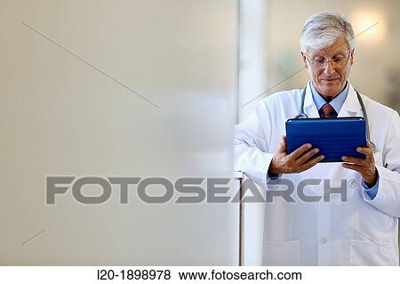 Doctor with tablet in corridor, Onkologikoa Hospital, Oncology Institute, Case Center for prevention, diagnosis and treatment of cancer, Donostia, San Sebastian, Gipuzkoa, Basque Country, Spain View Large Photo Image Stock Photo - Doctor with tablet in corridor, Onkologikoa Hospital, Oncology Institute, Case Center for prevention, diagnosis and treatment of cancer, Donostia, San Sebastian, Gipuzkoa, Basque Country, Spain. Fotosearch