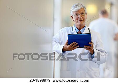 Doctor with tablet in corridor, Onkologikoa Hospital, Oncology Institute, Case Center for prevention, diagnosis and treatment of cancer, Donostia, San Sebastian, Gipuzkoa, Basque Country, Spain View Large Photo Image Stock Photo - Doctor with tablet in corridor, Onkologikoa Hospital, Oncology Institute, Case Center for prevention, diagnosis and treatment of cancer, Donostia, San Sebastian, Gipuzkoa, Basque Country, Spain. Fotosearch