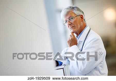 Stock Photo - Doctor with tablet in corridor, Onkologikoa Hospital, Oncology Institute, Case Center for prevention, diagnosis and treatment of cancer, Donostia, San Sebastian, Gipuzkoa, Basque Country, Spain. Fotosearch