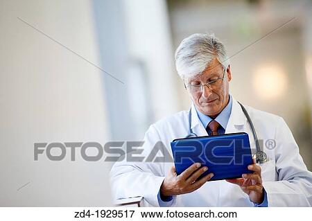 Doctor with tablet in corridor, Onkologikoa Hospital, Oncology Institute, Case Center for prevention, diagnosis and treatment of cancer, Donostia, San Sebastian, Gipuzkoa, Basque Country, Spain View Large Photo Image Stock Photo - Doctor with tablet in corridor, Onkologikoa Hospital, Oncology Institute, Case Center for prevention, diagnosis and treatment of cancer, Donostia, San Sebastian, Gipuzkoa, Basque Country, Spain. Fotosearch