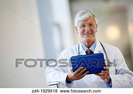 Doctor with tablet in corridor, Onkologikoa Hospital, Oncology Institute, Case Center for prevention, diagnosis and treatment of cancer, Donostia, San Sebastian, Gipuzkoa, Basque Country, Spain View Large Photo Image Stock Photo - Doctor with tablet in corridor, Onkologikoa Hospital, Oncology Institute, Case Center for prevention, diagnosis and treatment of cancer, Donostia, San Sebastian, Gipuzkoa, Basque Country, Spain. Fotosearch