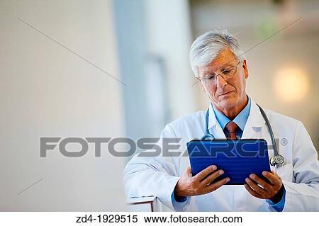 Doctor with tablet in corridor, Onkologikoa Hospital, Oncology Institute, Case Center for prevention, diagnosis and treatment of cancer, Donostia, San Sebastian, Gipuzkoa, Basque Country, Spain View Large Photo Image Stock Photography - Doctor with tablet in corridor, Onkologikoa Hospital, Oncology Institute, Case Center for prevention, diagnosis and treatment of cancer, Donostia, San Sebastian, Gipuzkoa, Basque Country, Spain. Fotosearch