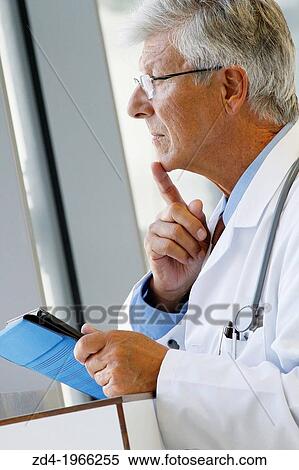 Stock Photography - Doctor with tablet in corridor, Onkologikoa Hospital, Oncology Institute, Case Center for prevention, diagnosis and treatment of cancer, Donostia, San Sebastian, Gipuzkoa, Basque Country, Spain. Fotosearch