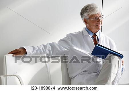 Doctor with tablet in waiting room, Onkologikoa Hospital, Oncology Institute, Case Center for prevention, diagnosis and treatment of cancer, Donostia, San Sebastian, Gipuzkoa, Basque Country, Spain View Large Photo Image Picture - Doctor with tablet in waiting room, Onkologikoa Hospital, Oncology Institute, Case Center for prevention, diagnosis and treatment of cancer, Donostia, San Sebastian, Gipuzkoa, Basque Country, Spain. Fotosearch
