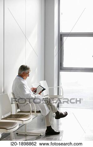 Doctor with tablet in waiting room, Onkologikoa Hospital, Oncology Institute, Case Center for prevention, diagnosis and treatment of cancer, Donostia, San Sebastian, Gipuzkoa, Basque Country, Spain View Large Photo Image Stock Image - Doctor with tablet in waiting room, Onkologikoa Hospital, Oncology Institute, Case Center for prevention, diagnosis and treatment of cancer, Donostia, San Sebastian, Gipuzkoa, Basque Country, Spain. Fotosearch
