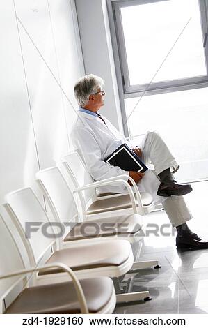 Stock Image - Doctor with tablet in waiting room, Onkologikoa Hospital, Oncology Institute, Case Center for prevention, diagnosis and treatment of cancer, Donostia, San Sebastian, Gipuzkoa, Basque Country, Spain. Fotosearch