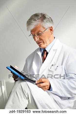 Doctor with tablet in waiting room, Onkologikoa Hospital, Oncology Institute, Case Center for prevention, diagnosis and treatment of cancer, Donostia, San Sebastian, Gipuzkoa, Basque Country, Spain View Large Photo Image Stock Image - Doctor with tablet in waiting room, Onkologikoa Hospital, Oncology Institute, Case Center for prevention, diagnosis and treatment of cancer, Donostia, San Sebastian, Gipuzkoa, Basque Country, Spain. Fotosearch