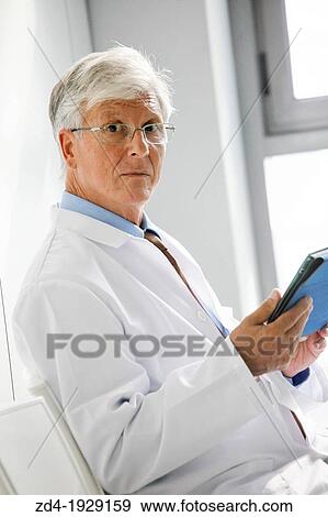 Doctor with tablet in waiting room, Onkologikoa Hospital, Oncology Institute, Case Center for prevention, diagnosis and treatment of cancer, Donostia, San Sebastian, Gipuzkoa, Basque Country, Spain View Large Photo Image Stock Photo - Doctor with tablet in waiting room, Onkologikoa Hospital, Oncology Institute, Case Center for prevention, diagnosis and treatment of cancer, Donostia, San Sebastian, Gipuzkoa, Basque Country, Spain. Fotosearch
