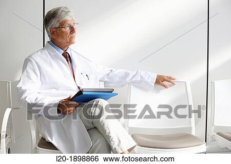 Doctor with tablet in waiting room, Onkologikoa Hospital, Oncology Institute, Case Center for prevention, diagnosis and treatment of cancer, Donostia, San Sebastian, Gipuzkoa, Basque Country, Spain View Large Photo Image Stock Photograph - Doctor with tablet in waiting room, Onkologikoa Hospital, Oncology Institute, Case Center for prevention, diagnosis and treatment of cancer, Donostia, San Sebastian, Gipuzkoa, Basque Country, Spain. Fotosearch