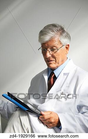 Doctor with tablet in waiting room, Onkologikoa Hospital, Oncology Institute, Case Center for prevention, diagnosis and treatment of cancer, Donostia, San Sebastian, Gipuzkoa, Basque Country, Spain View Large Photo Image Stock Photograph - Doctor with tablet in waiting room, Onkologikoa Hospital, Oncology Institute, Case Center for prevention, diagnosis and treatment of cancer, Donostia, San Sebastian, Gipuzkoa, Basque Country, Spain. Fotosearch