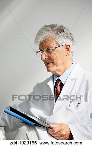 Stock Photography - Doctor with tablet in waiting room, Onkologikoa Hospital, Oncology Institute, Case Center for prevention, diagnosis and treatment of cancer, Donostia, San Sebastian, Gipuzkoa, Basque Country, Spain. Fotosearch