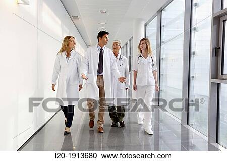Stock Image - Doctors and nurses walking in corridor, Onkologikoa Hospital, Oncology Institute, Case Center for prevention, diagnosis and treatment of cancer, Donostia, San Sebastian, Gipuzkoa, Basque Country, Spain. Fotosearch