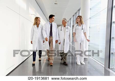 Stock Image - Doctors and nurses walking in corridor, Onkologikoa Hospital, Oncology Institute, Case Center for prevention, diagnosis and treatment of cancer, Donostia, San Sebastian, Gipuzkoa, Basque Country, Spain. Fotosearch