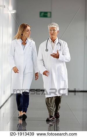 Stock Photo - Doctors and nurses walking in corridor, Onkologikoa Hospital, Oncology Institute, Case Center for prevention, diagnosis and treatment of cancer, Donostia, San Sebastian, Gipuzkoa, Basque Country, Spain. Fotosearch
