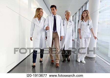 Stock Photo - Doctors and nurses walking in corridor, Onkologikoa Hospital, Oncology Institute, Case Center for prevention, diagnosis and treatment of cancer, Donostia, San Sebastian, Gipuzkoa, Basque Country, Spain. Fotosearch