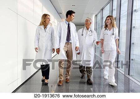 Stock Photograph - Doctors and nurses walking in corridor, Onkologikoa Hospital, Oncology Institute, Case Center for prevention, diagnosis and treatment of cancer, Donostia, San Sebastian, Gipuzkoa, Basque Country, Spain. Fotosearch