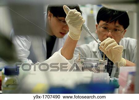 Stock Image - Doctors do laboratory work at a medical center in Singapore. Fotosearch
