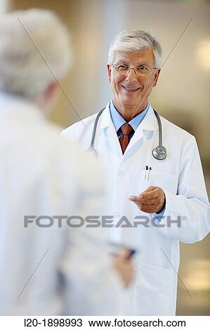 Stock Image - Doctors with stethoscope and tablet in corridor, Onkologikoa Hospital, Oncology Institute, Case Center for prevention, diagnosis and treatment of cancer, Donostia, San Sebastian, Gipuzkoa, Basque Country, Spain. Fotosearch