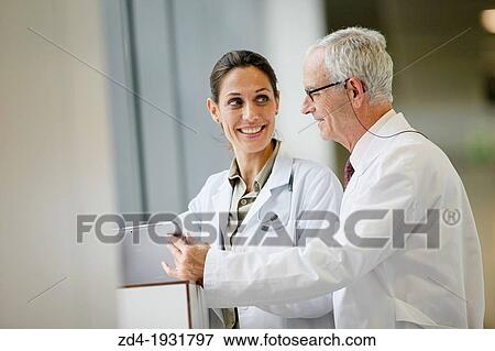Doctors with tablet in corridor, Onkologikoa Hospital, Oncology Institute, Case Center for prevention, diagnosis and treatment of cancer, Donostia, San Sebastian, Gipuzkoa, Basque Country, Spain View Large Photo Image Stock Photo - Doctors with tablet in corridor, Onkologikoa Hospital, Oncology Institute, Case Center for prevention, diagnosis and treatment of cancer, Donostia, San Sebastian, Gipuzkoa, Basque Country, Spain. Fotosearch