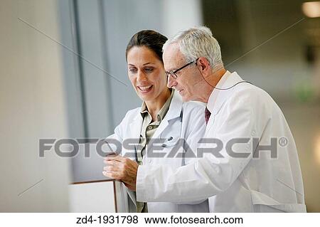 Doctors with tablet in corridor, Onkologikoa Hospital, Oncology Institute, Case Center for prevention, diagnosis and treatment of cancer, Donostia, San Sebastian, Gipuzkoa, Basque Country, Spain View Large Photo Image Stock Photo - Doctors with tablet in corridor, Onkologikoa Hospital, Oncology Institute, Case Center for prevention, diagnosis and treatment of cancer, Donostia, San Sebastian, Gipuzkoa, Basque Country, Spain. Fotosearch