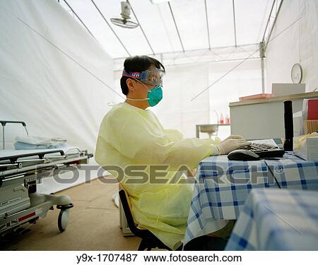 Doctors work in a temporary outdoor clinic set up during the SARS epidemic outbreak in Singapore View Large Photo Image Stock Photo - Doctors work in a temporary outdoor clinic set up during the SARS epidemic outbreak in Singapore. Fotosearch