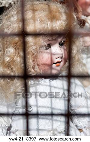 Doll behind shop grille. View Large Photo Image Stock Photo - Doll behind shop grille.. Fotosearch