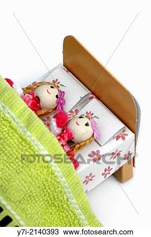 doll lying on bed. View Large Photo Image Stock Image - doll lying on bed.. Fotosearch
