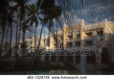 Stock Photo - Dominican Republic, Punta Cana Region, Bavaro, Iberostar Grand Hotel, viewed through mesh curtains. Fotosearch