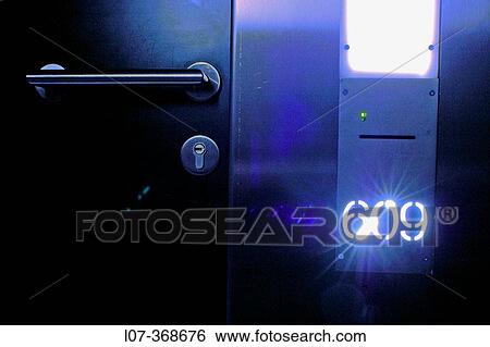 Stock Photograph - Door knob and room number in modern hotel. Hotel Omm. Barcelona. Spain. Fotosearch