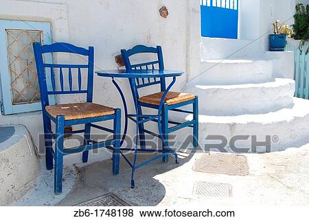 Dos sillas en una calle de Pyrgos Santorini Grecia View Large Photo Image Stock Photo - Dos sillas en una calle de Pyrgos Santorini Grecia. Fotosearch