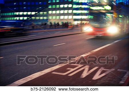 Double Decker bus in motion with the lights on and people walking through London Bridge at night. London, England, UK View Large Photo Image Stock Image - Double Decker bus in motion with the lights on and people walking through London Bridge at night. London, England, UK. Fotosearch