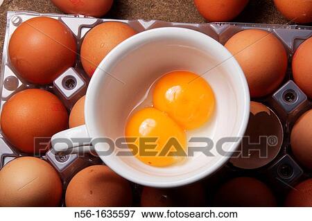 Stock Photo - Double Yolked Eggs on a cup. Fotosearch
